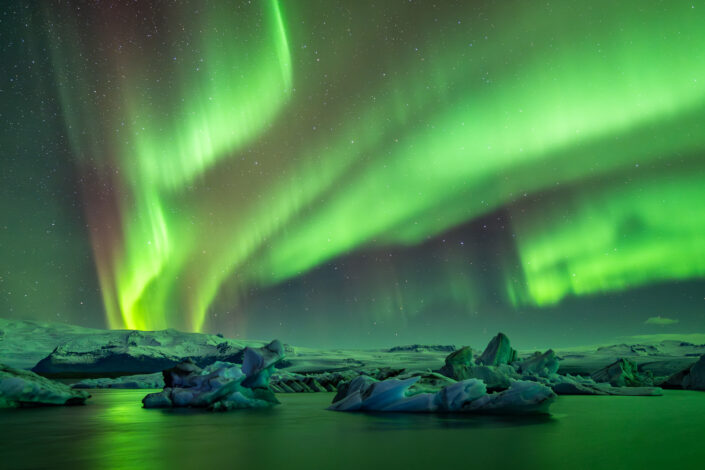 Nordlicht über Eisbergen in der Gletscherlagune Jökulsarlon